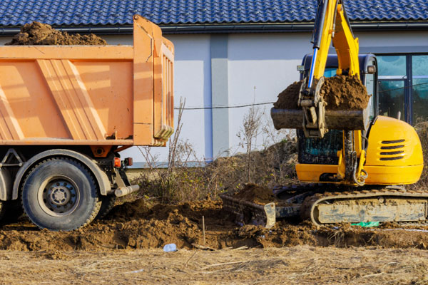 Mini excavator filling truck