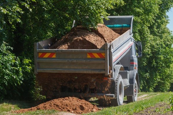 Dump truck dropping a load of dirt